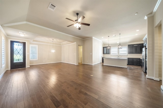 unfurnished living room featuring dark hardwood / wood-style flooring, ceiling fan, crown molding, sink, and lofted ceiling