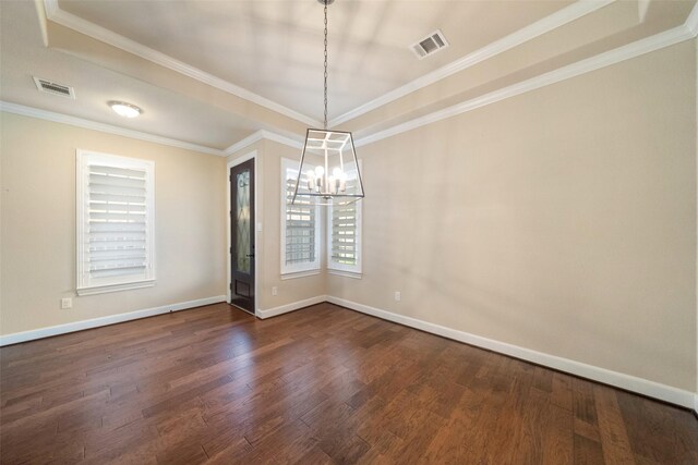 empty room with dark hardwood / wood-style floors, an inviting chandelier, and ornamental molding