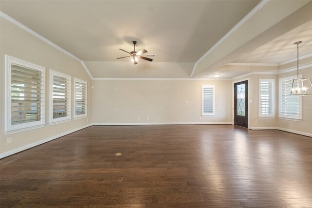 unfurnished living room featuring ceiling fan with notable chandelier, lofted ceiling, dark wood-type flooring, and ornamental molding