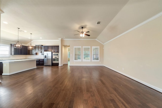 unfurnished living room featuring plenty of natural light, lofted ceiling, ornamental molding, and ceiling fan with notable chandelier