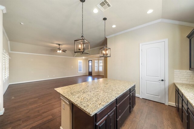 kitchen with ornamental molding, ceiling fan, pendant lighting, a center island, and dark hardwood / wood-style floors