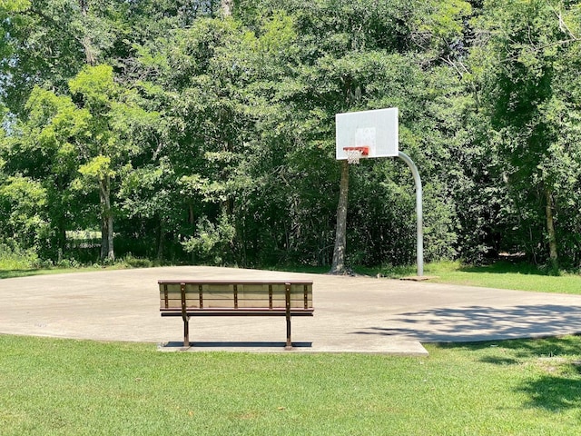 view of basketball court featuring a yard