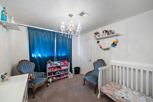 carpeted bedroom with a textured ceiling, a crib, and a notable chandelier