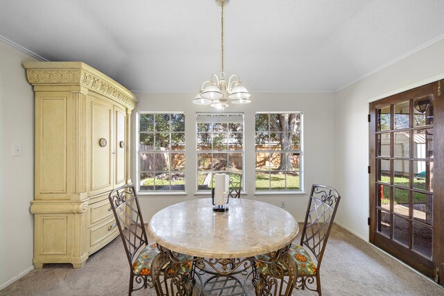 carpeted dining space with a chandelier and ornamental molding