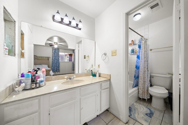 full bathroom featuring shower / bath combination with curtain, vanity, ceiling fan, tile patterned flooring, and toilet