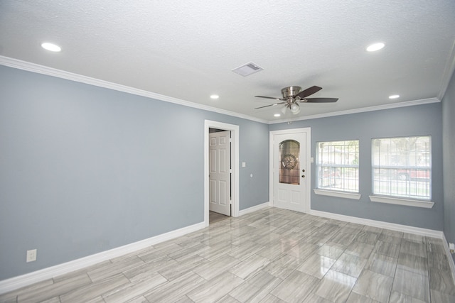 unfurnished room featuring ceiling fan, a textured ceiling, and crown molding