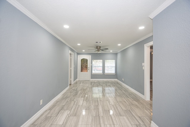 empty room featuring ornamental molding, a textured ceiling, and ceiling fan