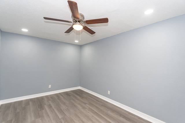 empty room with a textured ceiling, hardwood / wood-style flooring, and ceiling fan