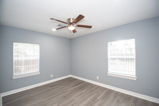 empty room featuring ceiling fan and dark hardwood / wood-style floors