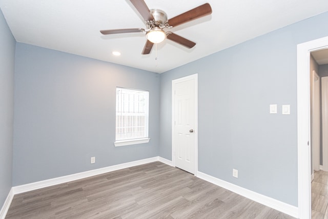 unfurnished room featuring light wood-type flooring and ceiling fan