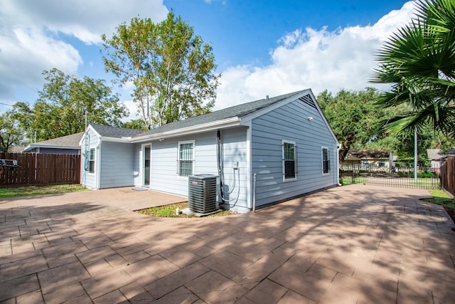 back of house featuring cooling unit and a patio