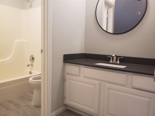 full bathroom featuring hardwood / wood-style floors, vanity, shower / bathtub combination, and toilet