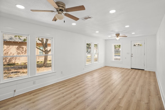 unfurnished living room featuring ceiling fan and light hardwood / wood-style floors