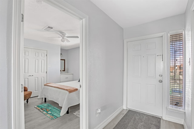 foyer entrance featuring light wood-type flooring and ceiling fan