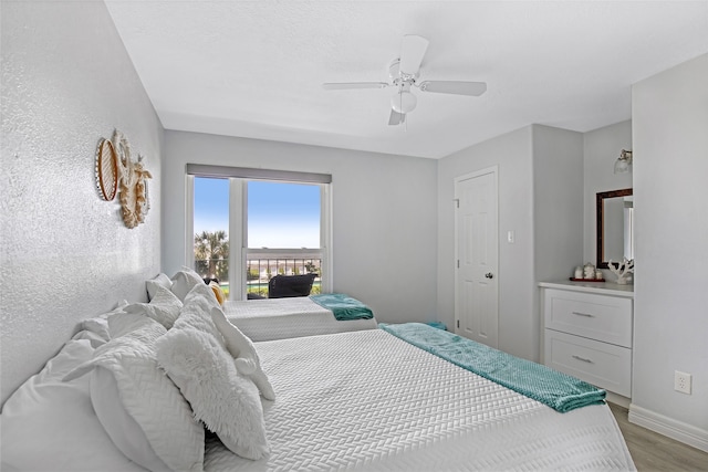 bedroom featuring light hardwood / wood-style floors and ceiling fan