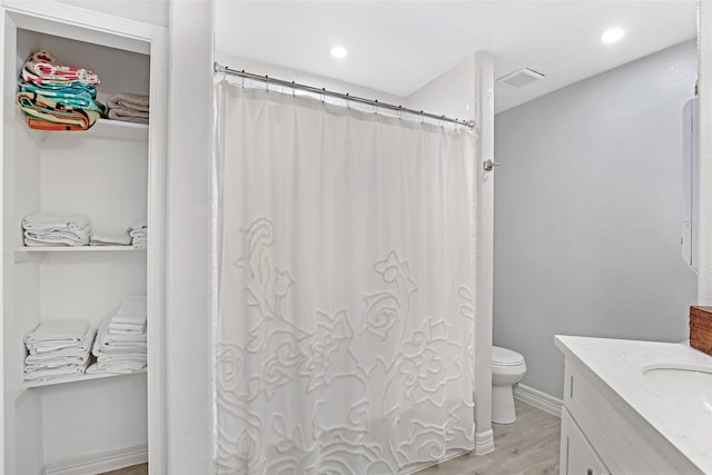 bathroom featuring hardwood / wood-style flooring, vanity, and toilet