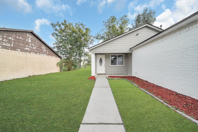 doorway to property featuring a yard