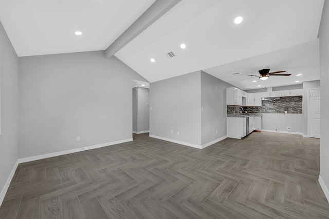 unfurnished living room with lofted ceiling with beams, dark parquet flooring, sink, and ceiling fan