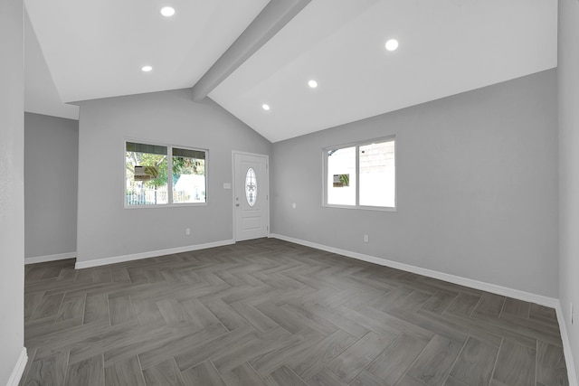 empty room with plenty of natural light, vaulted ceiling with beams, and dark parquet floors