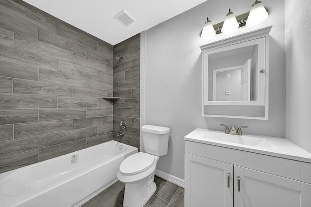 full bathroom with toilet, vanity, and tiled shower / bath