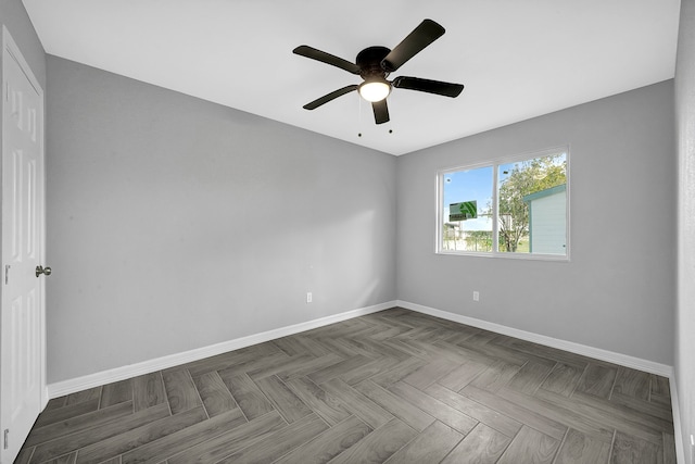 unfurnished room featuring ceiling fan and dark parquet floors