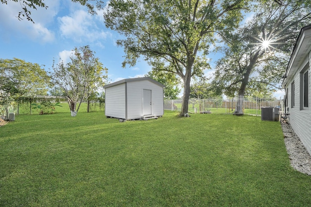 view of yard featuring a shed and central AC unit