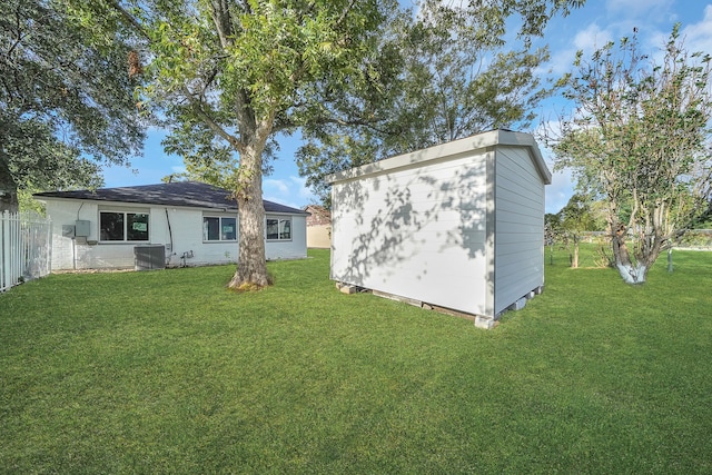 exterior space with central air condition unit and a yard