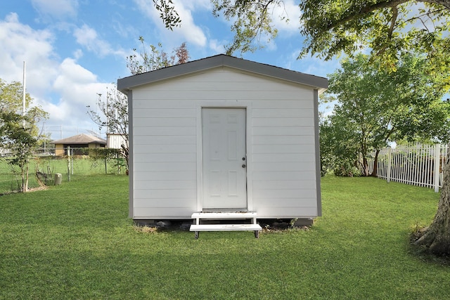 view of outbuilding with a lawn