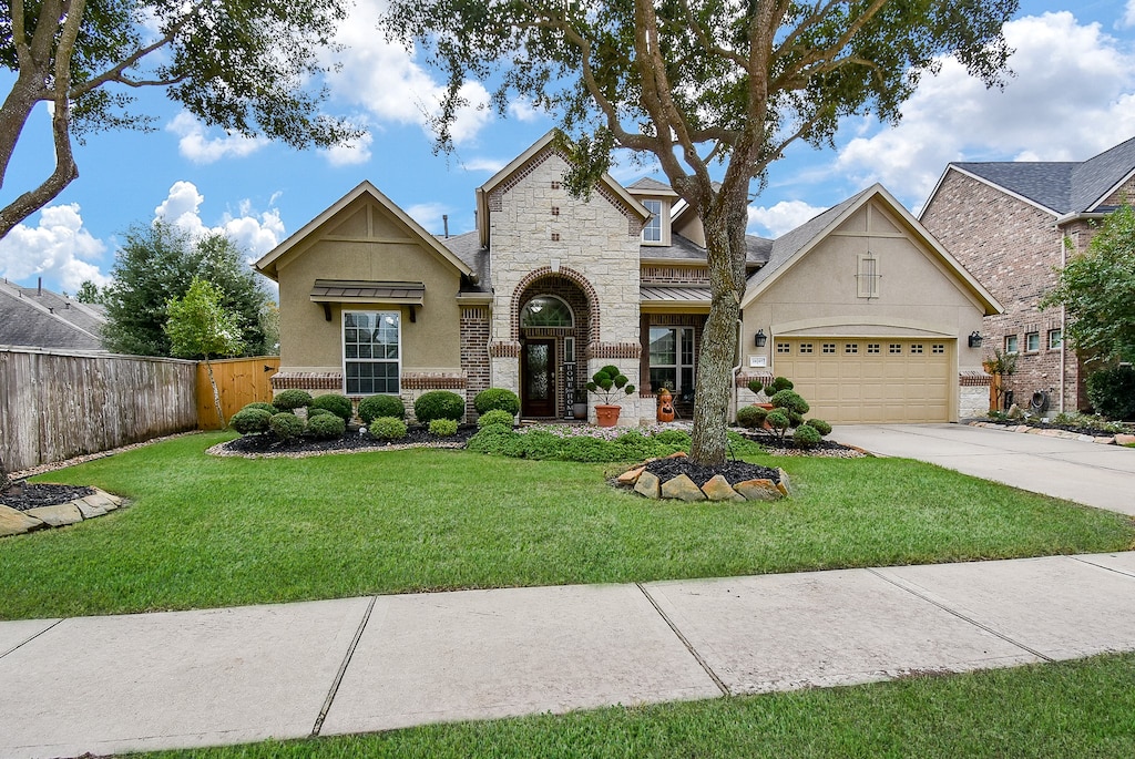 view of front of home with a garage and a front yard