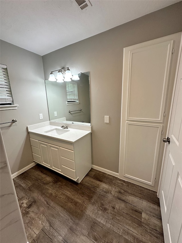 bathroom with vanity and hardwood / wood-style flooring