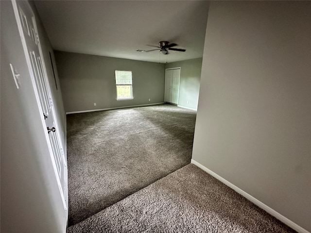 spare room featuring ceiling fan and carpet flooring