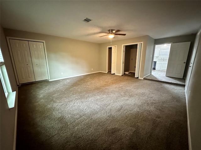 unfurnished bedroom featuring sink, ceiling fan, and carpet floors