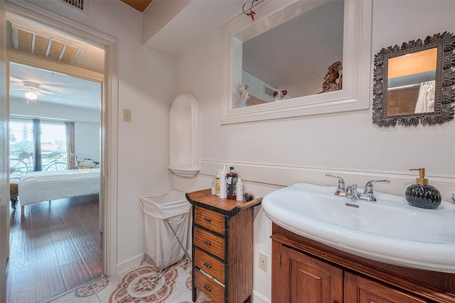 bathroom with hardwood / wood-style floors, ceiling fan, and vanity