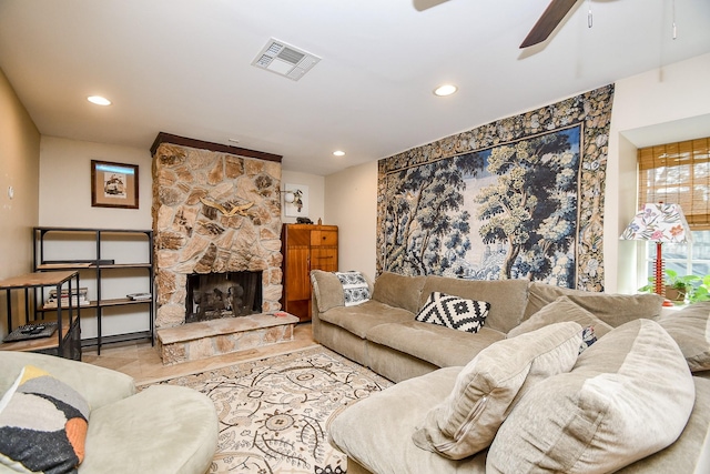 living room featuring ceiling fan and a fireplace