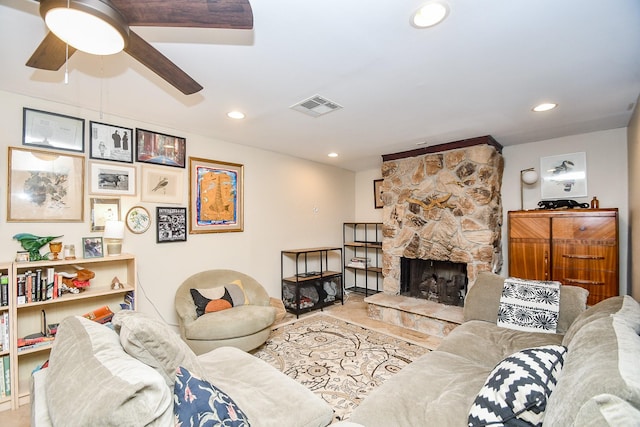 living room with ceiling fan, a fireplace, and light tile patterned floors