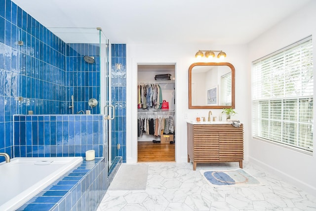 bathroom featuring vanity and independent shower and bath