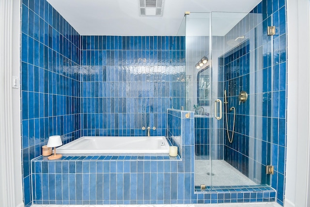 bathroom featuring independent shower and bath and tile walls