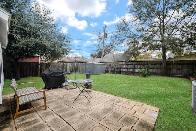 view of patio with a storage unit and grilling area