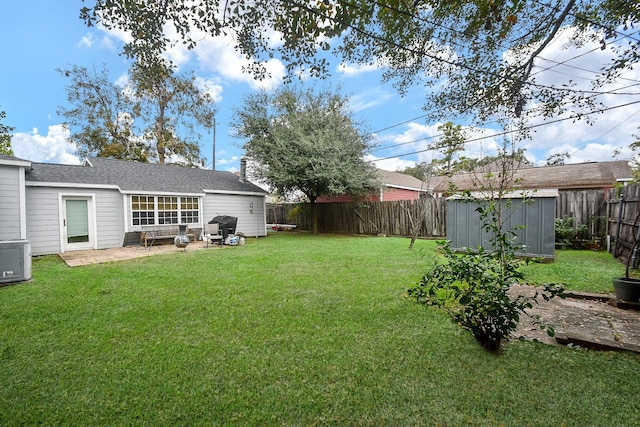 view of yard featuring a storage unit and a patio area