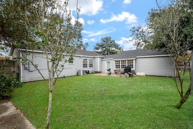 back of property featuring a yard, a patio, and central AC