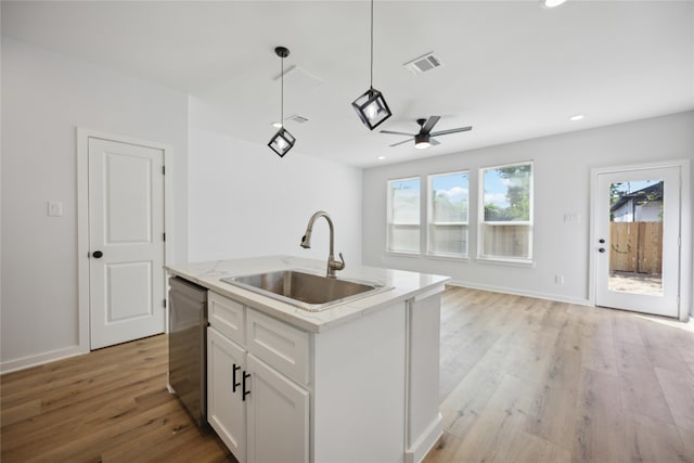 kitchen with dishwasher, white cabinetry, sink, and light hardwood / wood-style floors