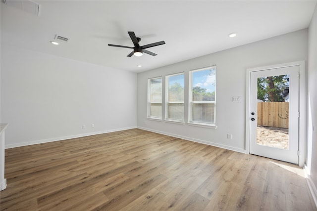 unfurnished room featuring ceiling fan, a healthy amount of sunlight, and light hardwood / wood-style flooring