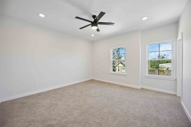 empty room with light carpet and ceiling fan