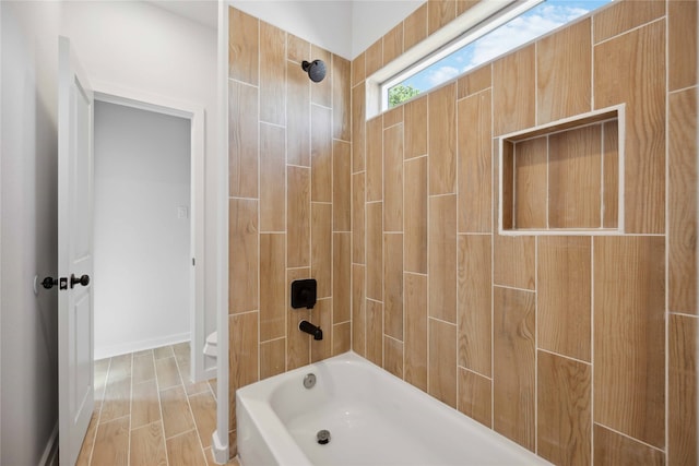 bathroom featuring hardwood / wood-style flooring and tiled shower / bath combo