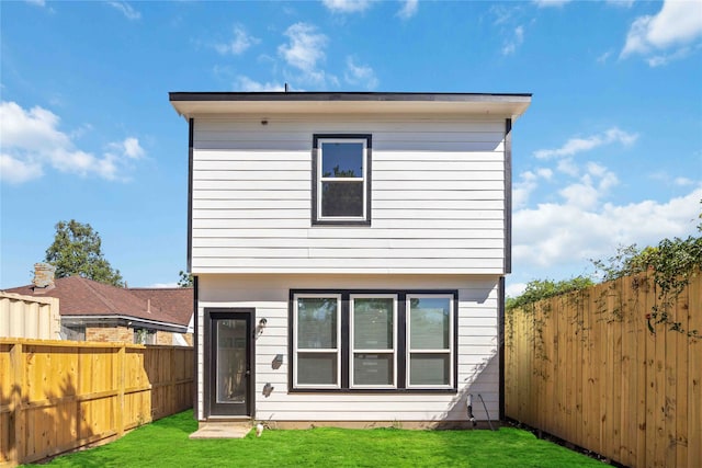 rear view of house with a yard