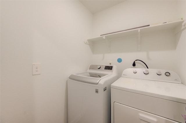 clothes washing area featuring washing machine and clothes dryer