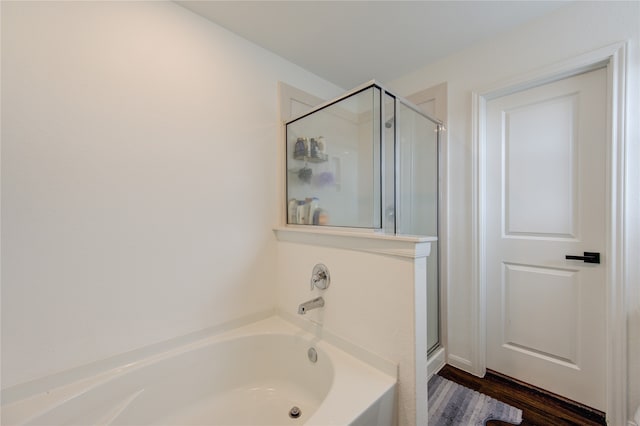 bathroom with wood-type flooring and plus walk in shower