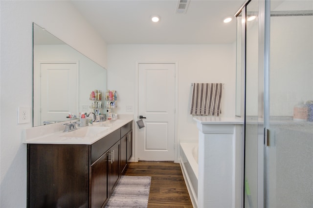 bathroom with shower with separate bathtub, vanity, and hardwood / wood-style flooring