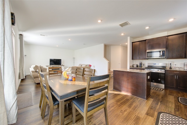 dining area with dark hardwood / wood-style flooring