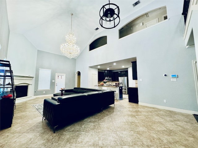 living room featuring high vaulted ceiling, tile patterned flooring, and an inviting chandelier